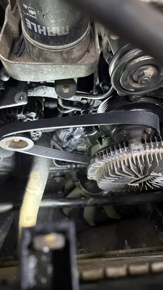 Auxiliary belt and pulley being checked from underneath